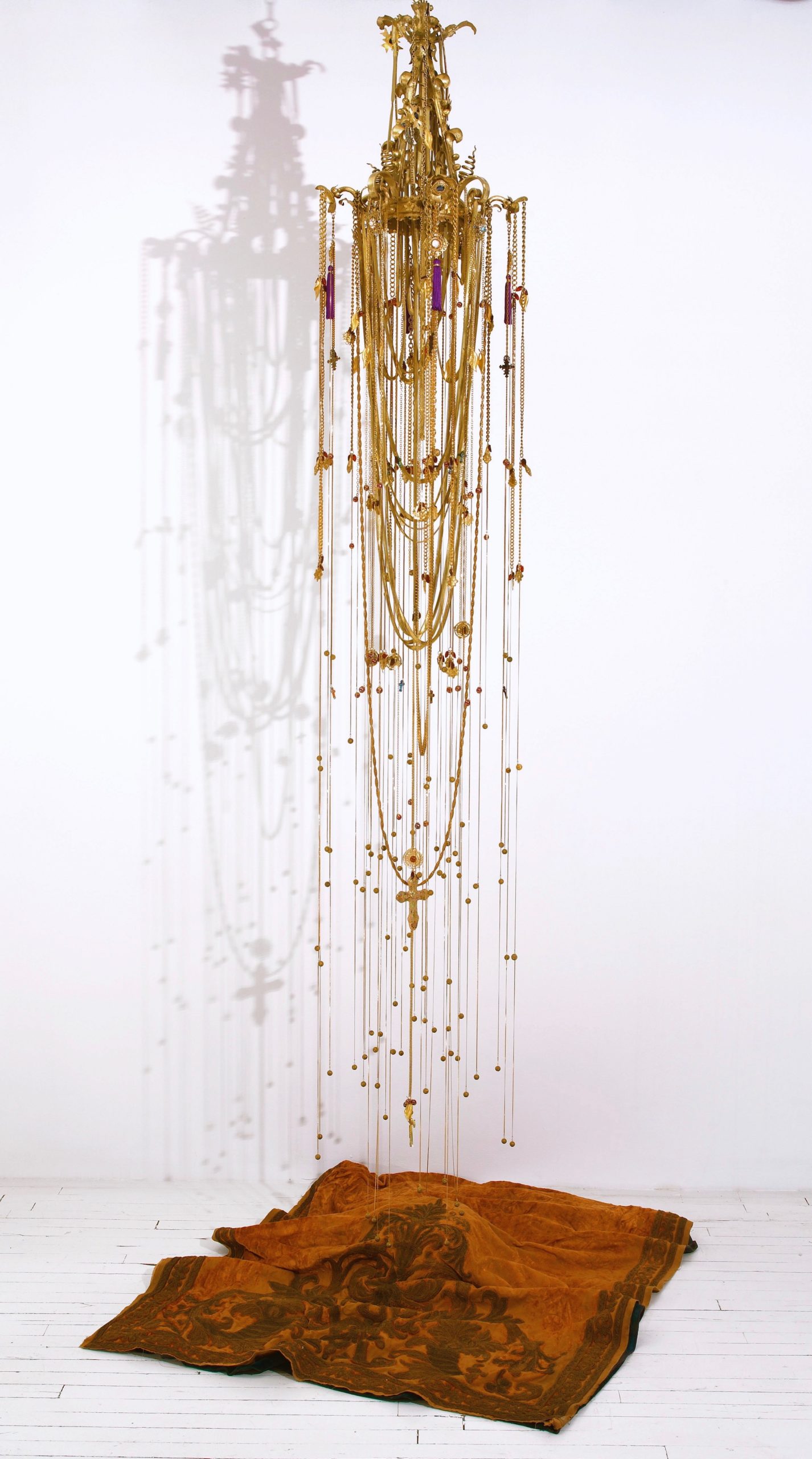 Esperanza Cortés; EMPIRE; 2016; Chandelier, gold leaf, 1000 feet of gold plated jewelry chain, gold plated metal leaves, brass beads, glass beads; 18' L x 6' Diameter. The history of colonial empire is the history of the Americas, specially places like my birthplace Colombia.